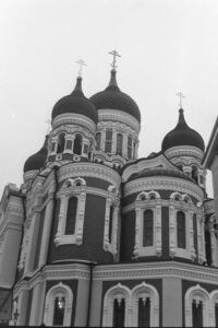 Black and white photo of a Russian style cathedral with onion domes.