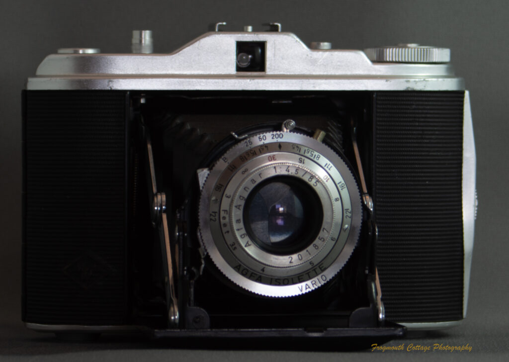 Photograph of an Agfa Isolette I camera - a folding medium format camera. The camera is open with the bellows folded out.