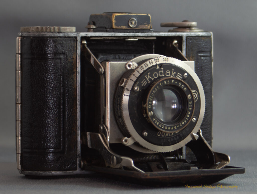 Photograph of a Kodak Vollenda 48 camera - a folding 127 roll film camera. The camera is open with the bellows folded out.