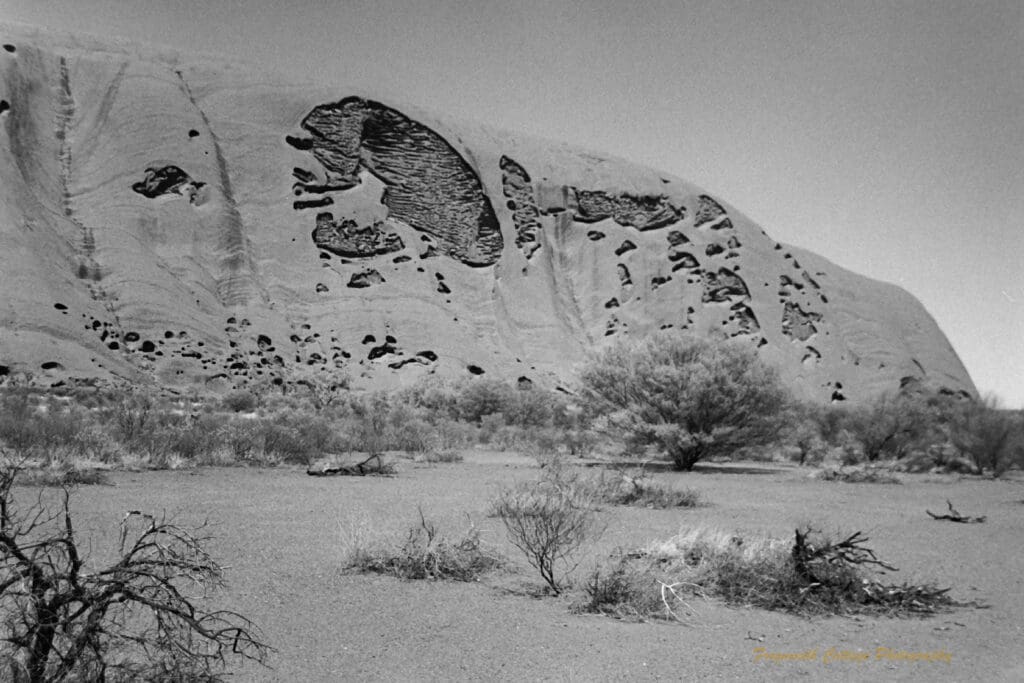 Black and white photograph of the side of Uluru